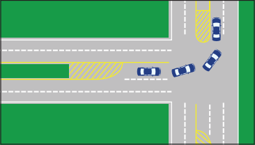 Diagonal yellow lines mark the road coming to an end, and cars use this lane to turn left