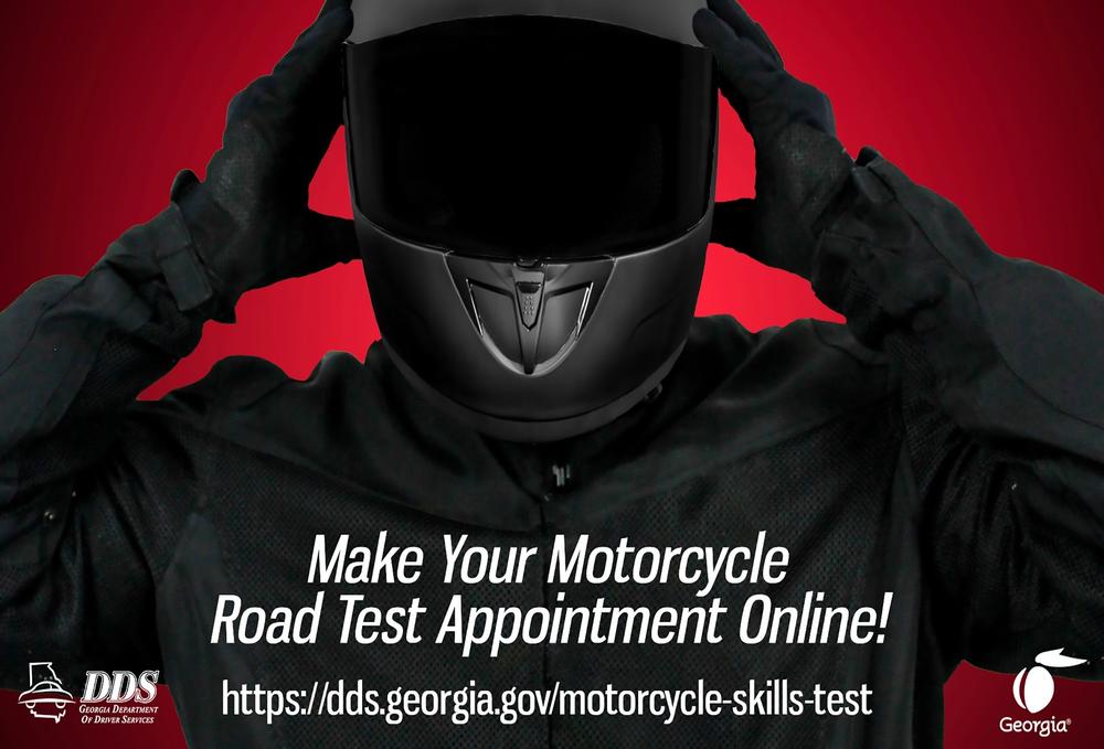 Motorcyclist putting on a helmet. Make your motorcycle road test appointment online! https://dds.georgia.gov/motorcycle-skills-test