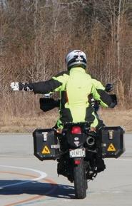 Motorcyclist with their left arm extended straight out