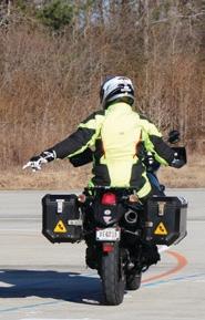 Motorcyclist with their left hand pointed down