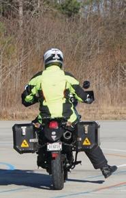 Motorcyclist with their right leg extended