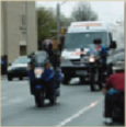 Motorcyclists and cars driving on a road