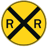 A yellow, circular railroad crossing sign