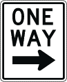 A white, vertical rectangular One Way sign
