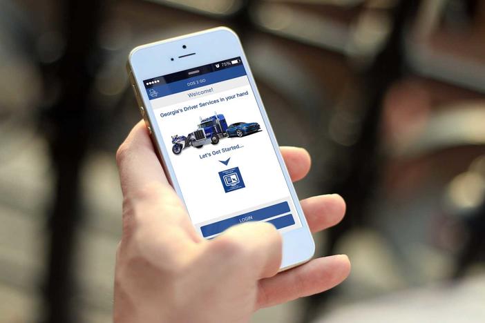 A hand holding a phone with the DDS 2 Go mobile app open.