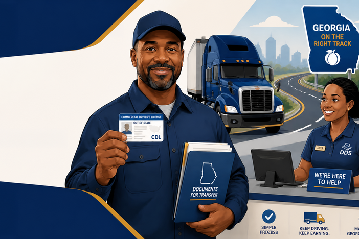 Man holding documents for transfer showing off his transferred commercial license after transferring his out of state license to a Georgia license.
